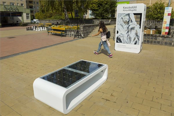 Kuube Nano solar smart bench with solar panels and Kuube Book public book exchange station in urban square