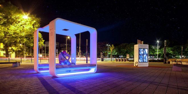 Kuube solar smart bench with LED lighting installed in urban public space at night