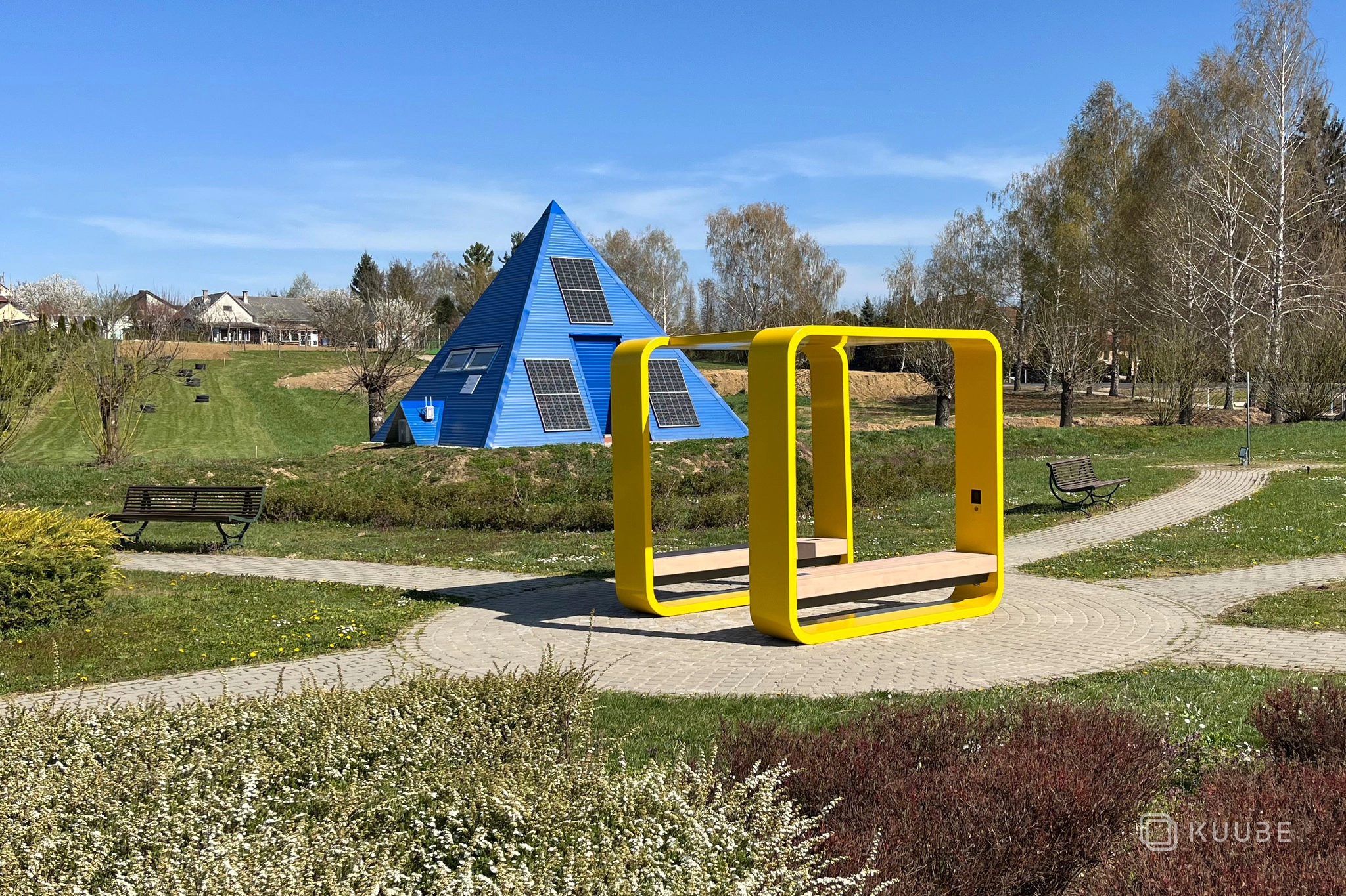 KUUBE outdoor smart furniture in a landscaped public park with solar-powered pavilion