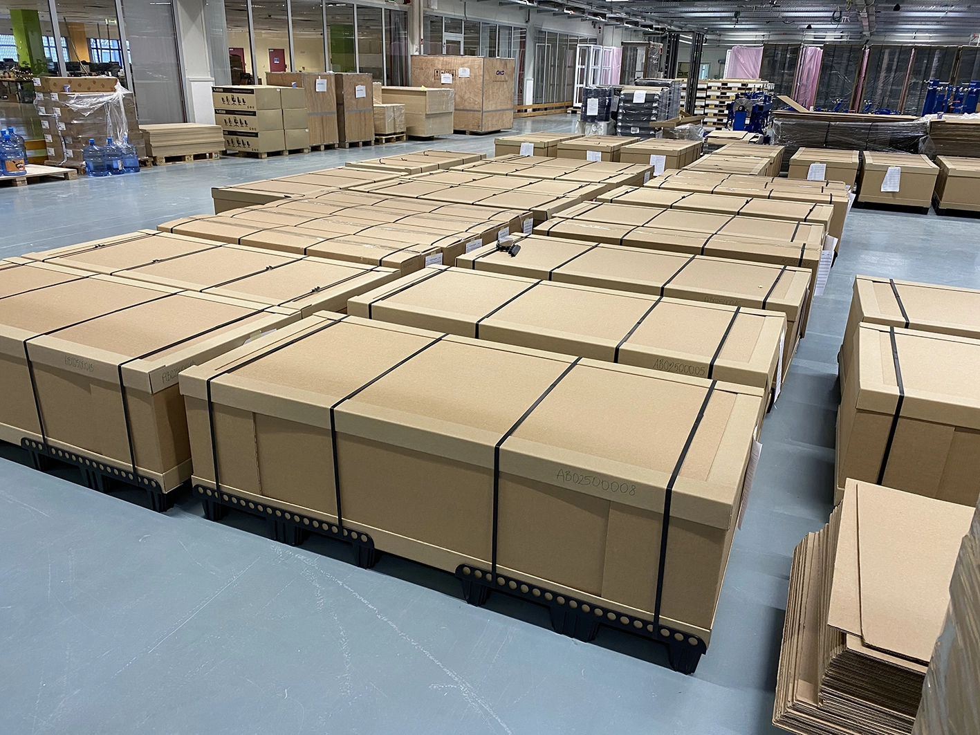 Rows of packaged Kuube smart city products on pallets ready for global shipment in a production facility