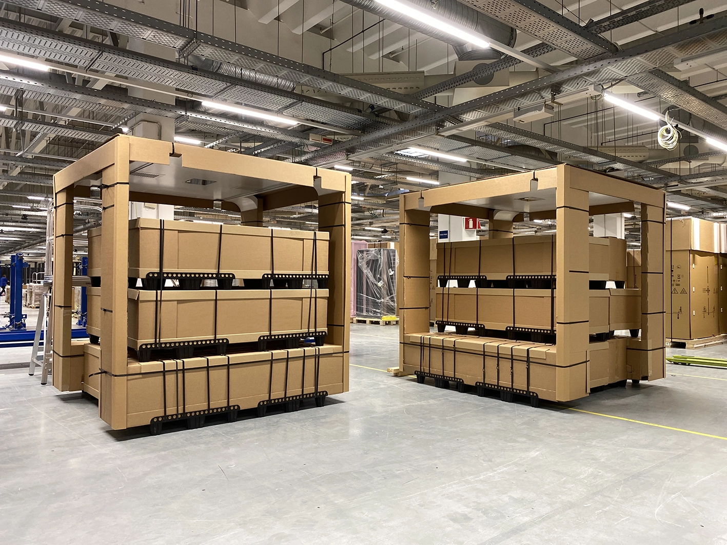 Large shipping crates with Kuube smart city products prepared for transport inside a manufacturing facility