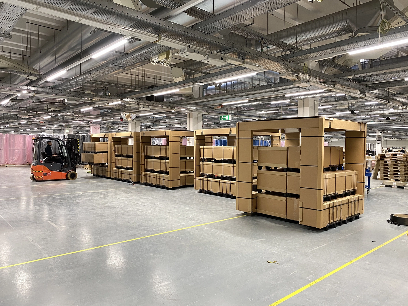 Kuube smart city products packaged on pallets inside a manufacturing and logistics facility